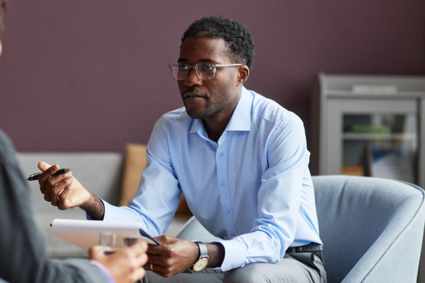 founder on a B2B sales call taking notes on prospect problems