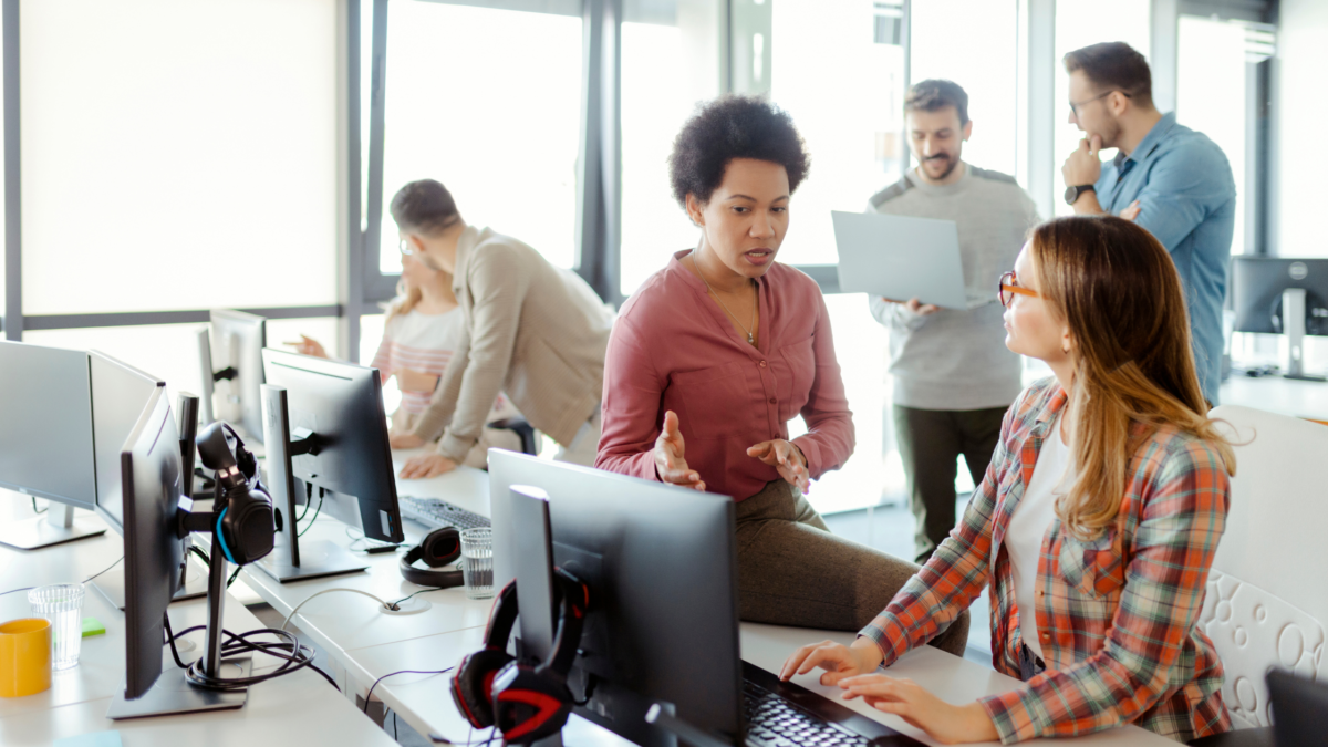 startup founder handing sales playbook to first salesperson